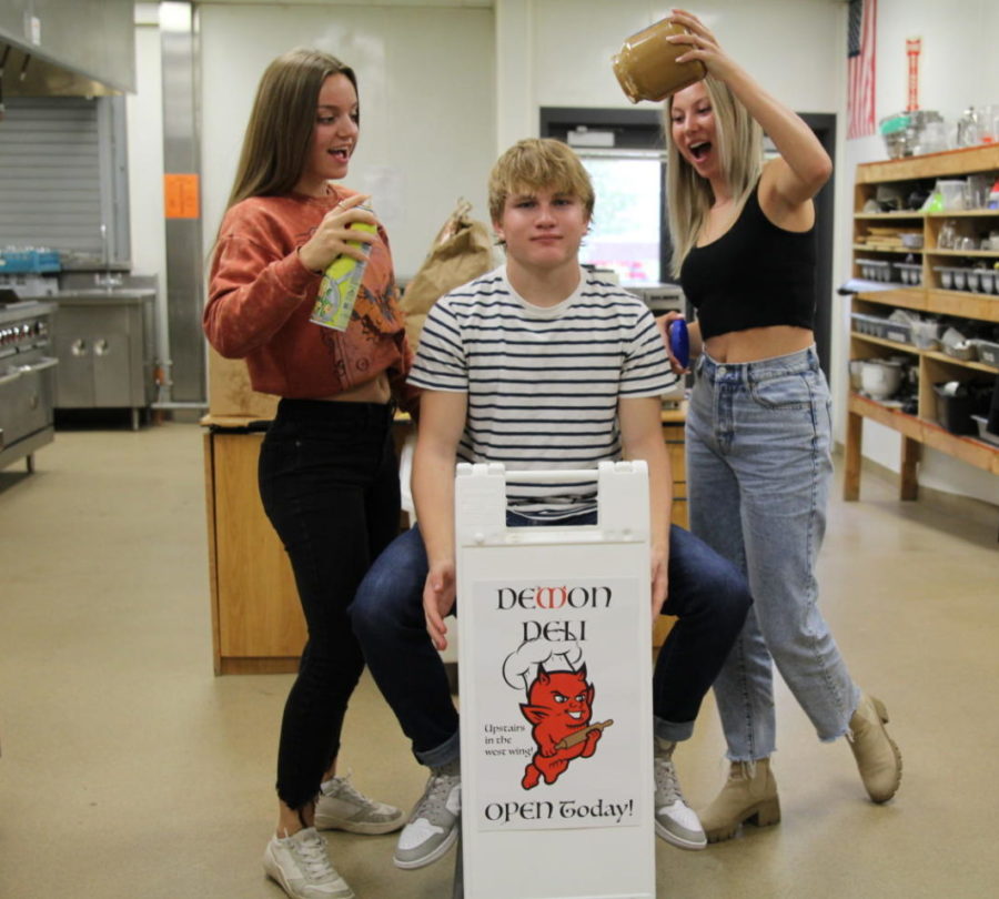 Prostart 2 students Reese Glover, Chris McGrath and Kiana Fullerton (left to right) with the Demon Deli sign that is set up outside the front entrance to Durango High School. 