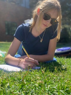 Molly Bertrand, a freshman at DHS, doing homework during lunch on the 29th of September, 2022 out front of DHS. 