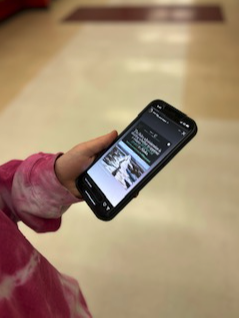 A student looking at an Instagram post that explains the Willow Project on March 9th, 2023 in DHS halls. 