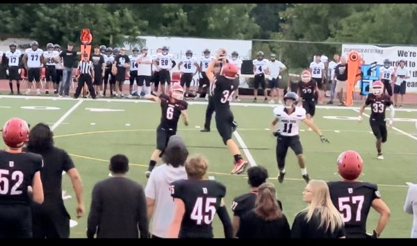 Dane Mattlock (9) catching the ball between the 40 and 30 yard line. Mattlock is playing defensive line on DHS Varsity makes an incredible catch to get the ball where it needs to go. A true inspiration to young athletes. 