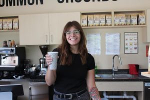 Owner of Common Grounds, Cassandra, holding up a drink!
