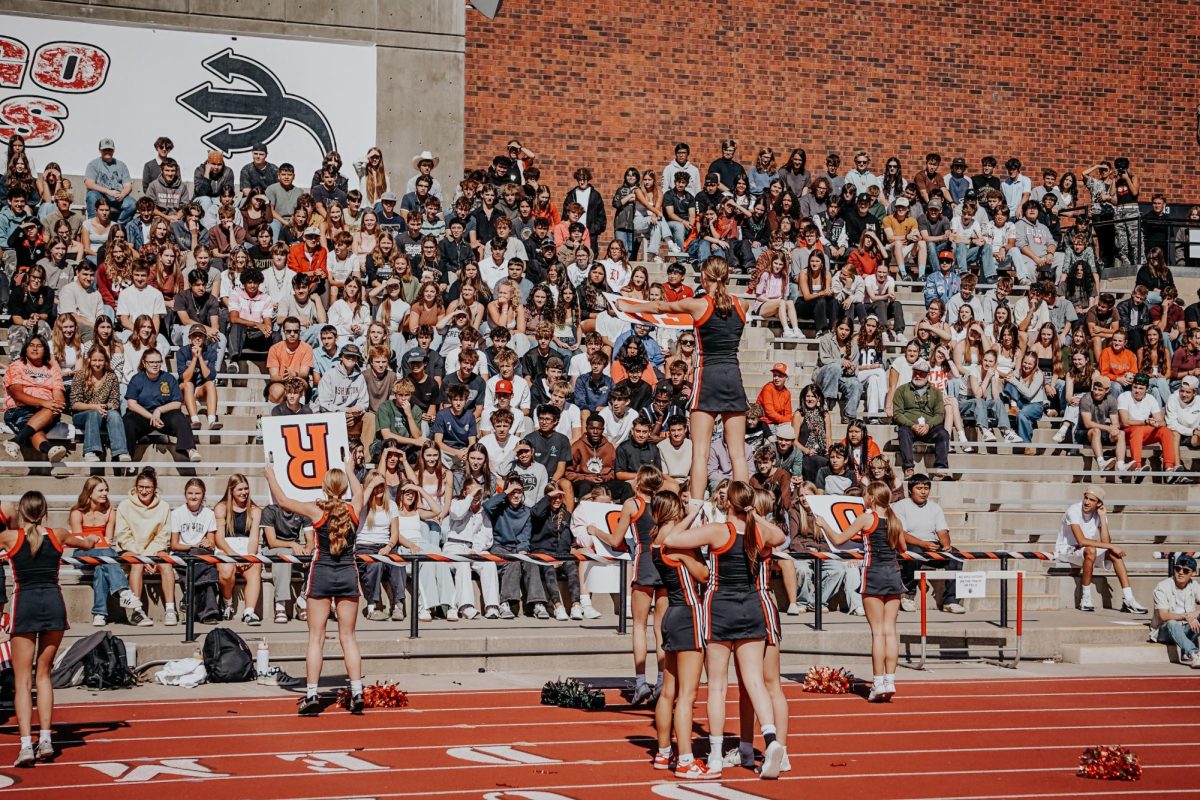 DHS Students watch the DHS Cheer Team perform a routine at the pep assembly on September 17, 2025